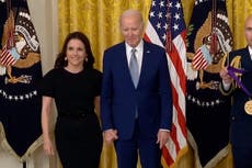 Joe Biden holds hands with Julia Louis-Dreyfus as he presents her National Medal of Arts