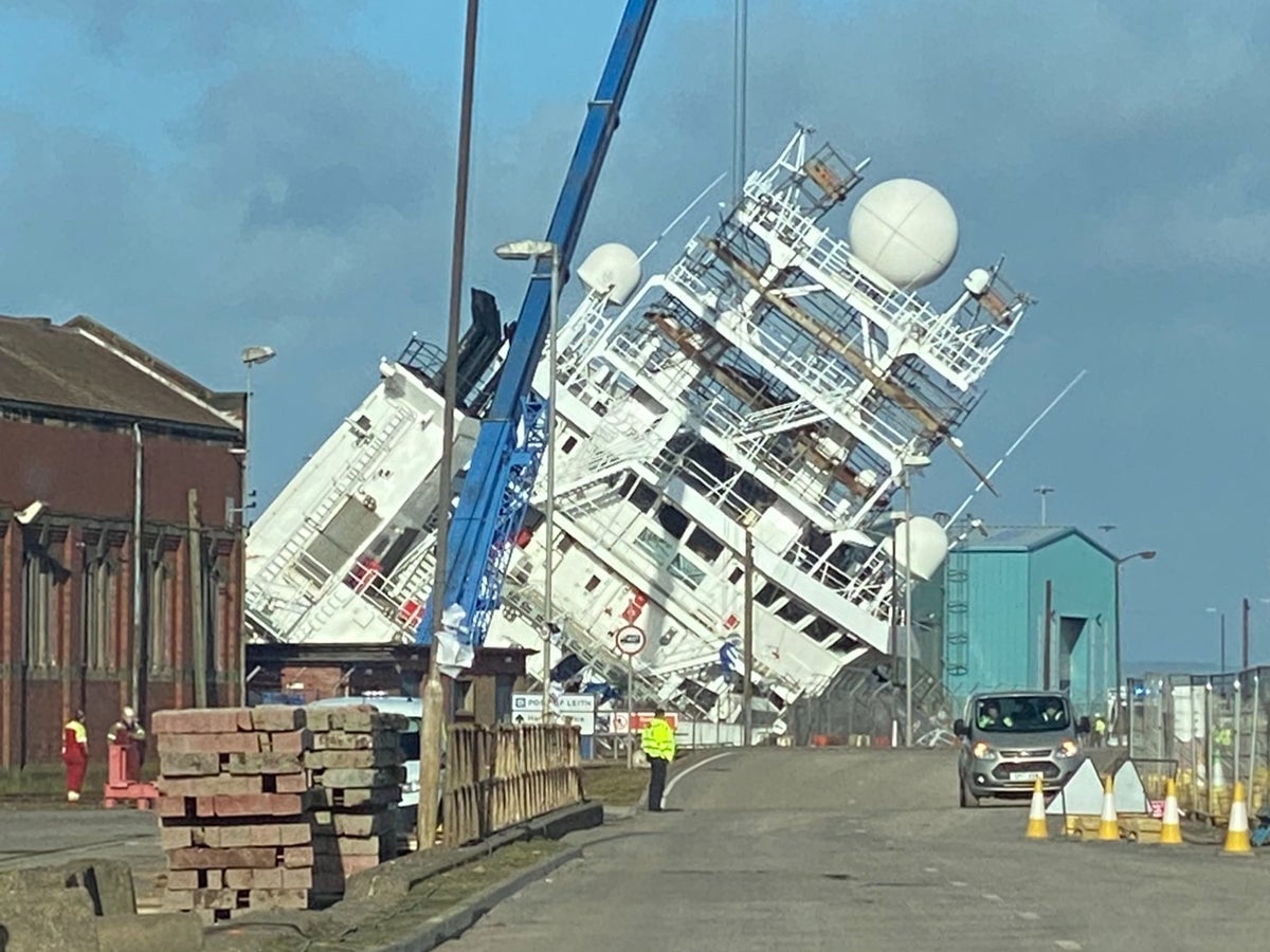 ‘Multiple injuries’ as huge ship topples over in dry dock during strong winds