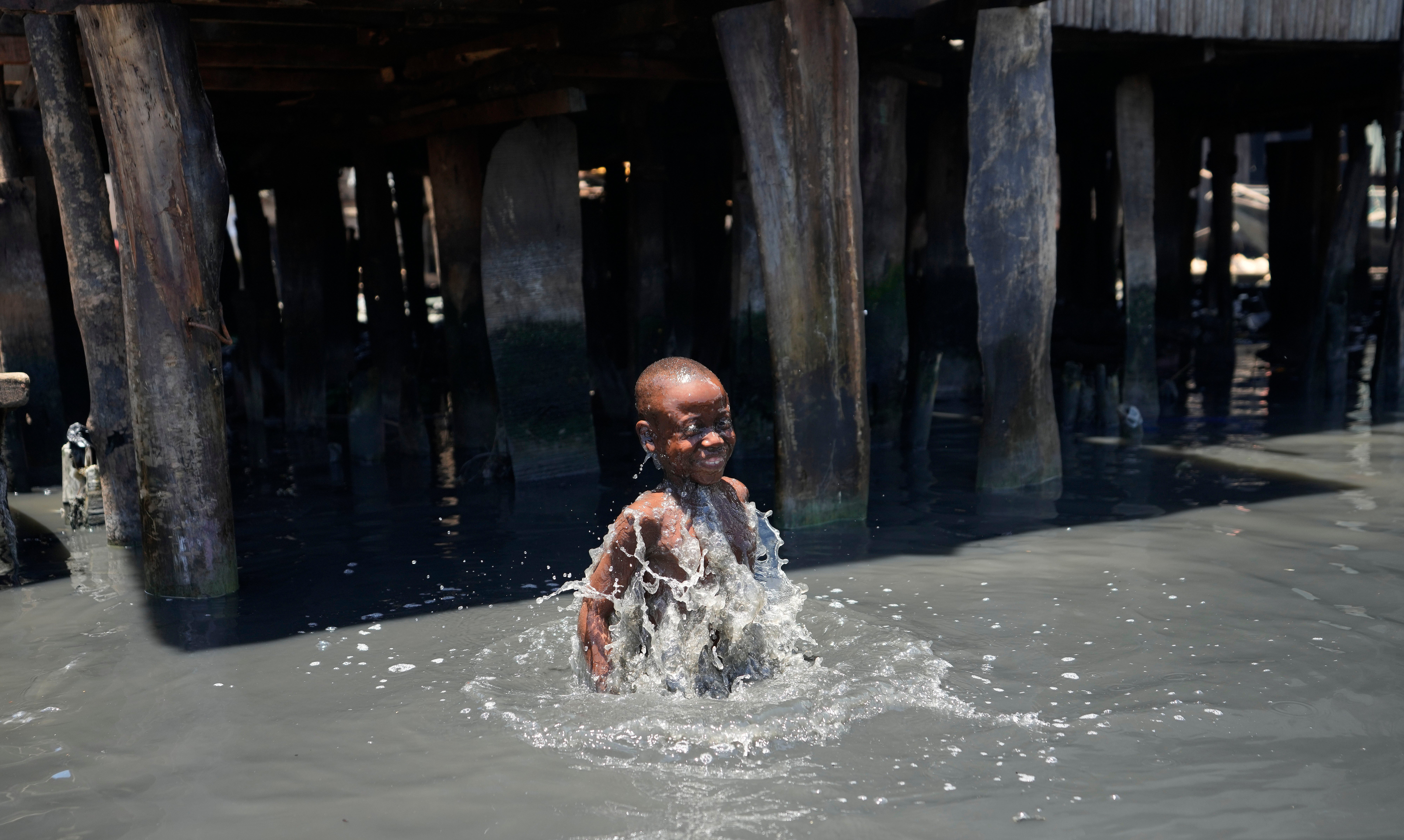 <p>A child plays in filthy water surrounded by garbage in Lagos' floating slum of Makoko on Monday. March 22 is World Water Day, established by the United Nations and marked annually since 1993 to raise awareness about access to clean water and sanitation. (AP Photo/Sunday Alamba)</p>