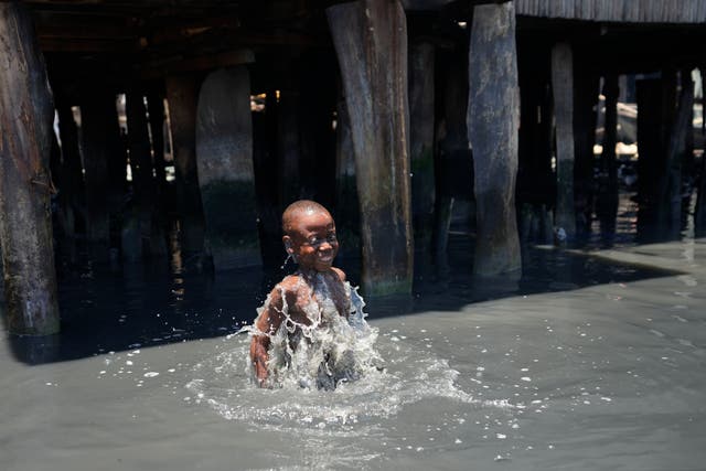 <p>A child plays in filthy water surrounded by garbage in Lagos' floating slum of Makoko on Monday. March 22 is World Water Day, established by the United Nations and marked annually since 1993 to raise awareness about access to clean water and sanitation. (AP Photo/Sunday Alamba)</p>