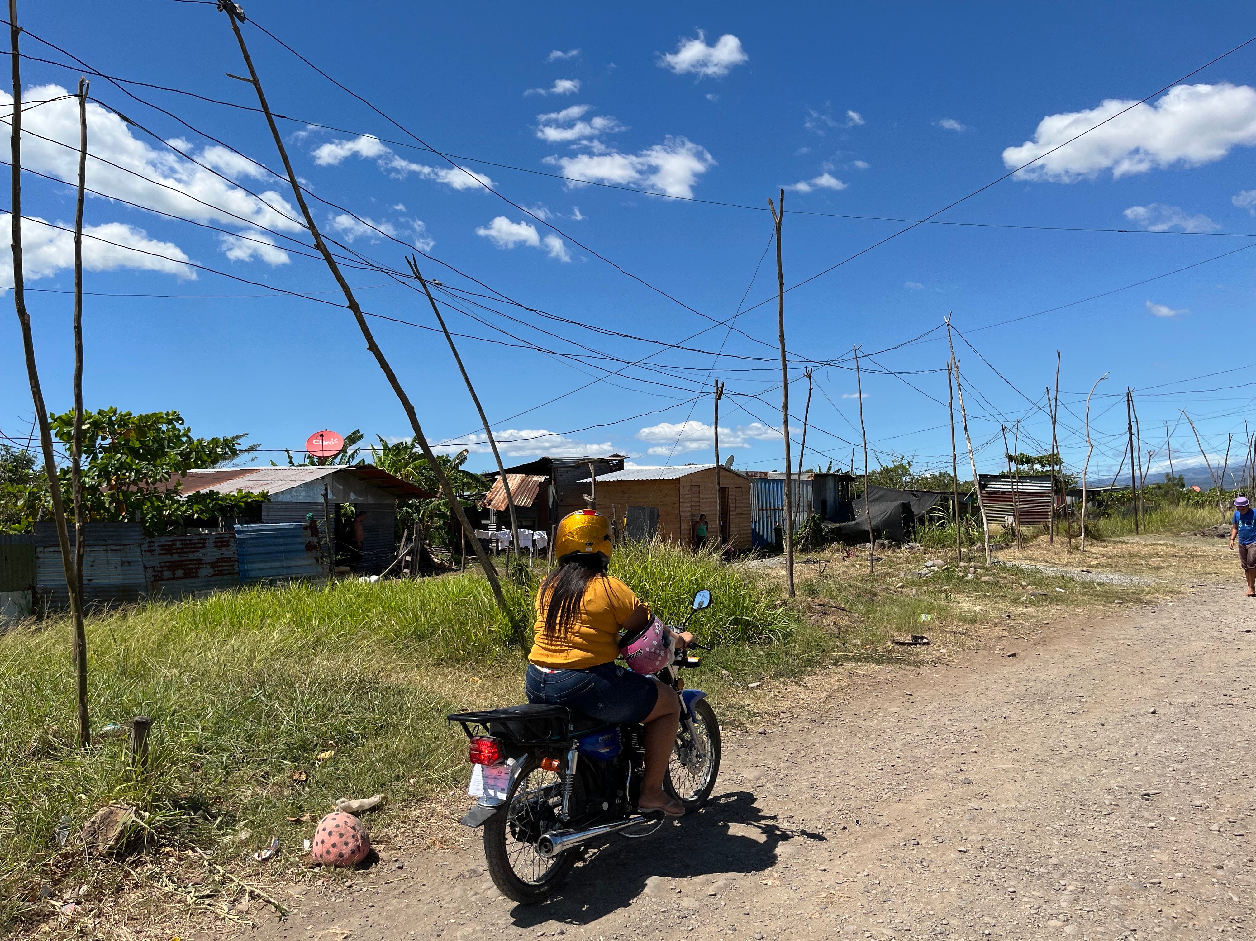 A young woman rides a motorcycle in Bella Vista