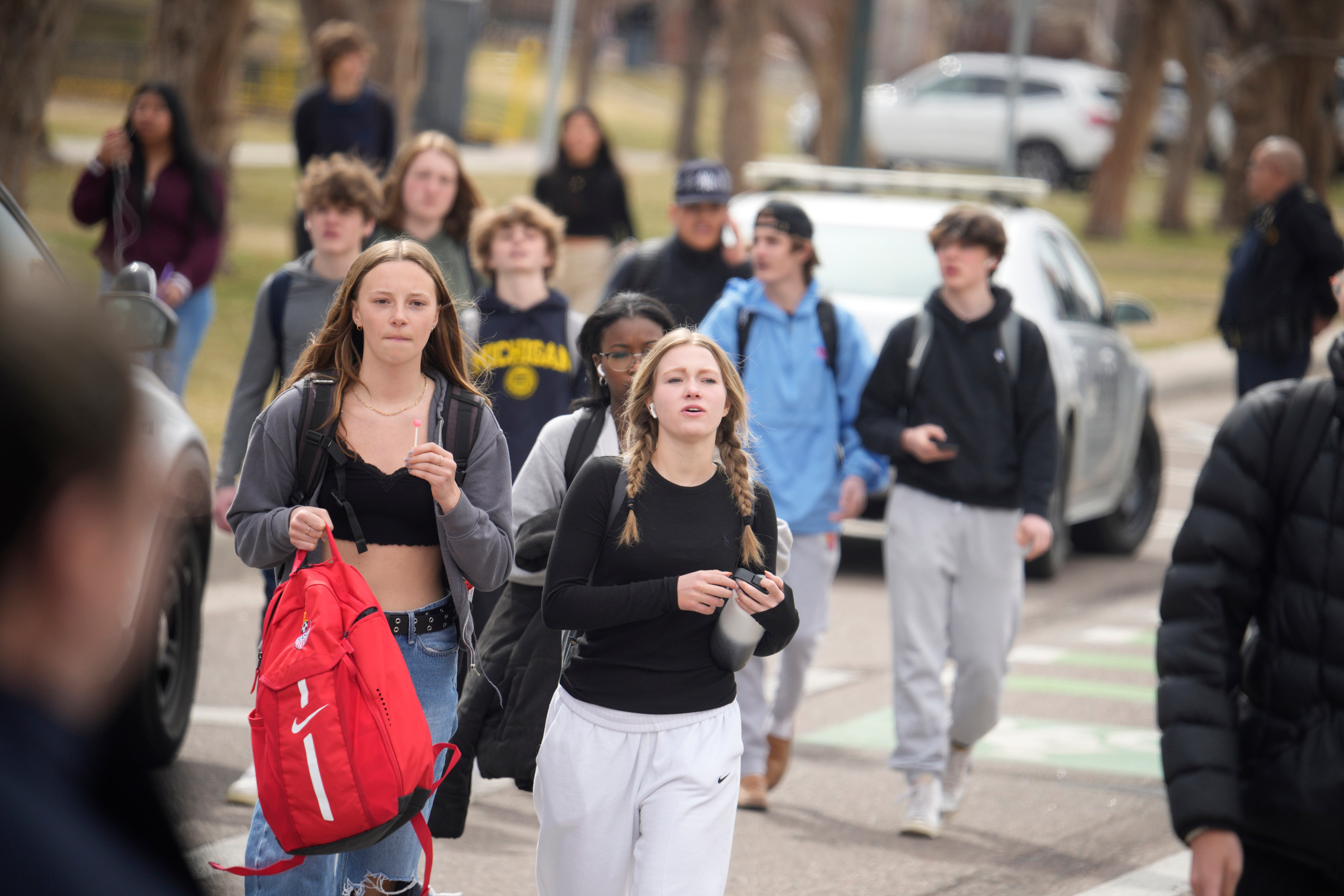 Students are walked out of East High School following a shooting, Wednesday, March 22, 2023, in Denver