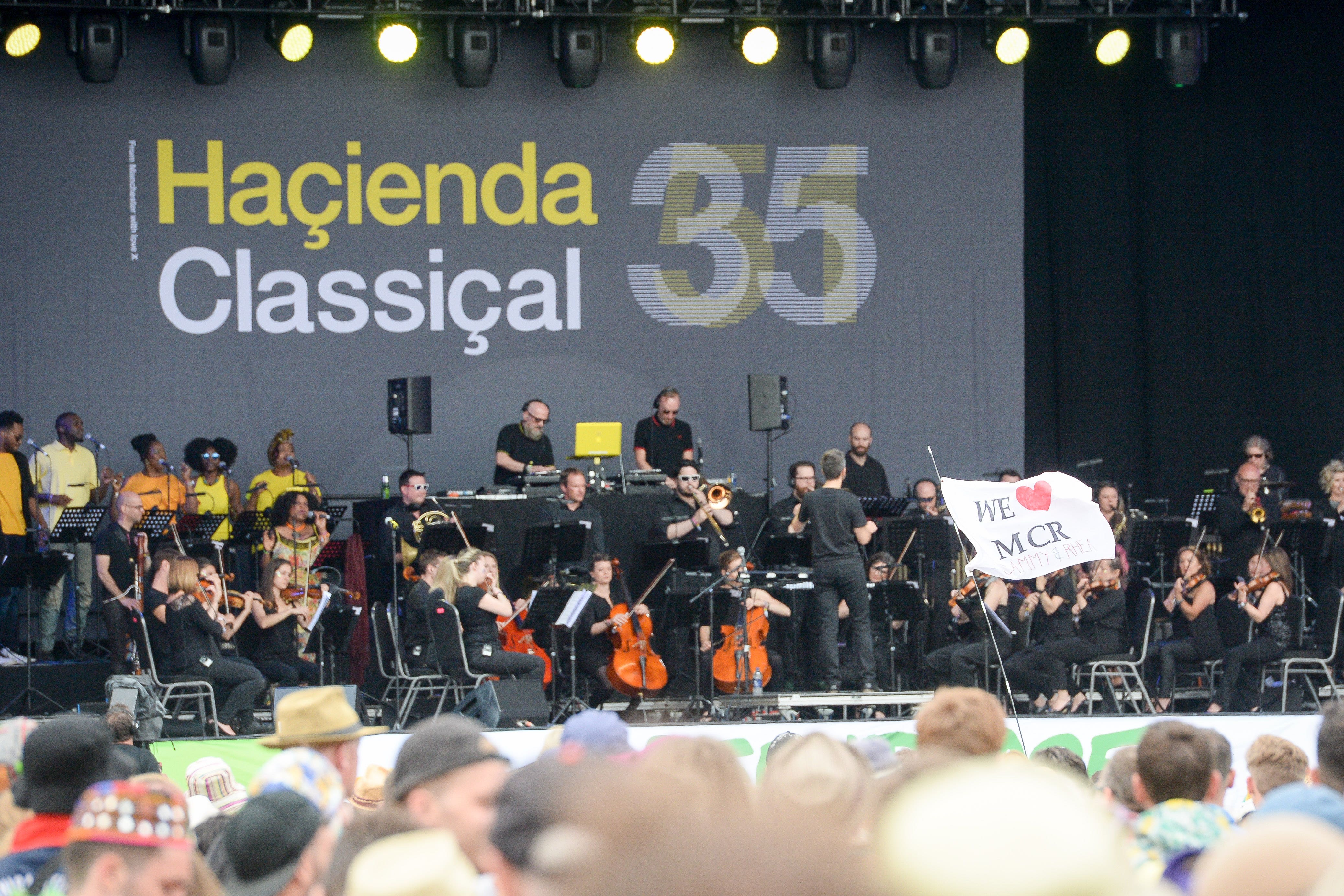 A ‘WE “HEART” MCR’ flag in front of the Pyramid stage, while the Hacienda Classical Orchestra opens the start of the music at the Glastonbury Festival, at Worthy Farm in Somerset (Ben Birchall/PA)