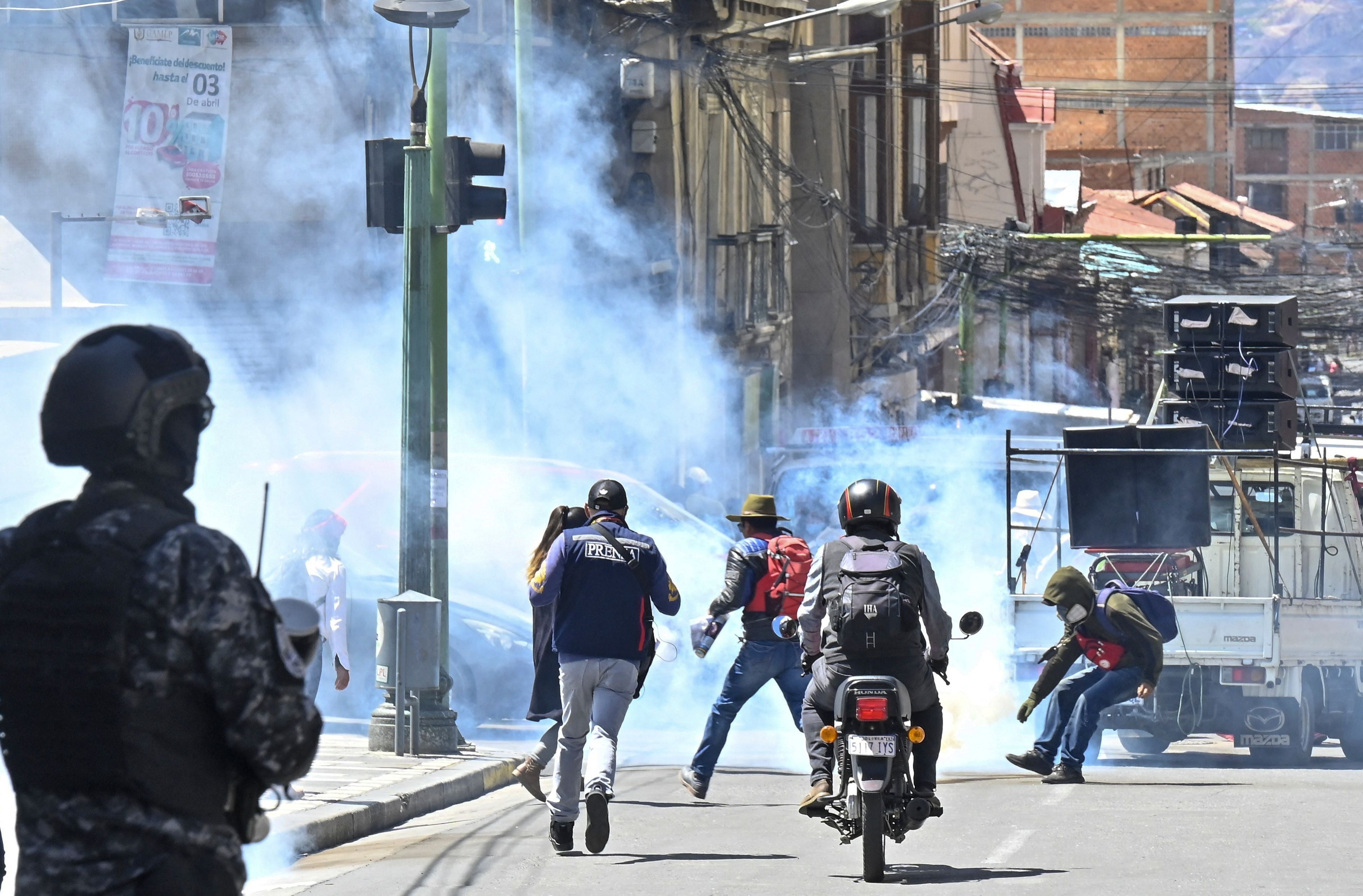 Riot police fire rubber bullets and tear gas at education workers during a protest demanding a bigger budget for the sector and rejecting a new education plan from Bolivian President Luis Arce’s government on 22 March