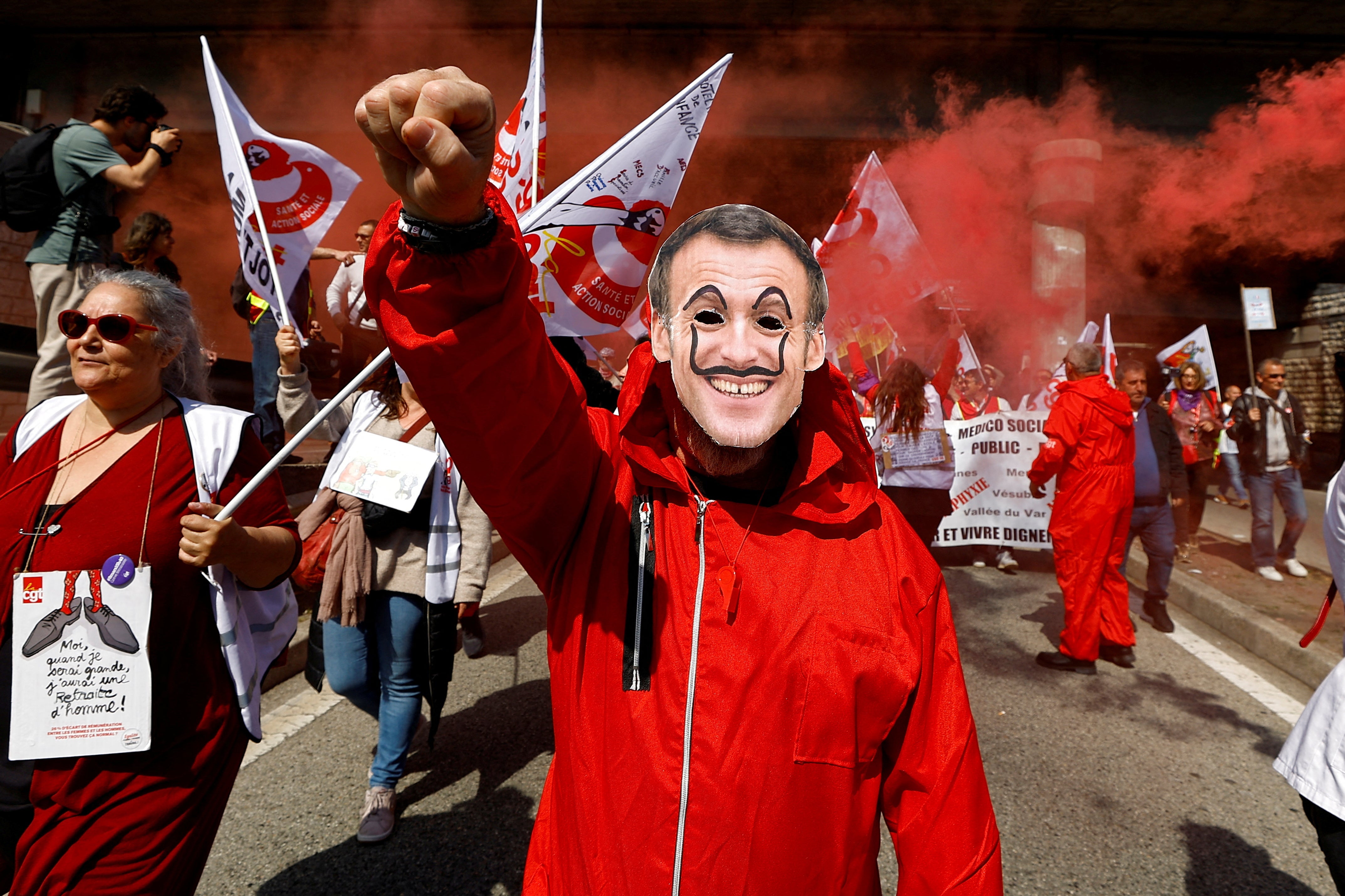 A protester wearing a Macron mask at a demonstration in Nice on Thursday
