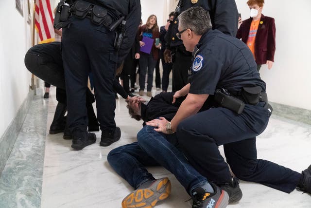 <p>Manuel Oliver, the father of Joaquin Oliver, one of the victims of the 2018 mass shooting at Marjory Stoneman Douglas High School in Parkland, Fla., is removed from the hearing room for disturbing a hearing on Capitol Hill in Washington, Thursday, March 23, 2023</p>