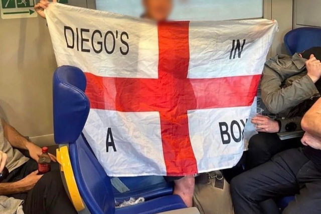 <p>An England fan shows off the offensive flag</p>