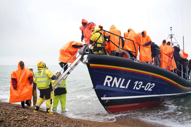 <p>A group of people thought to be migrants are brought onto Dungeness beach in Kent</p>