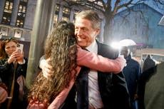 Hugh Grant smiles and hugs fans at Dungeons and Dragons premiere