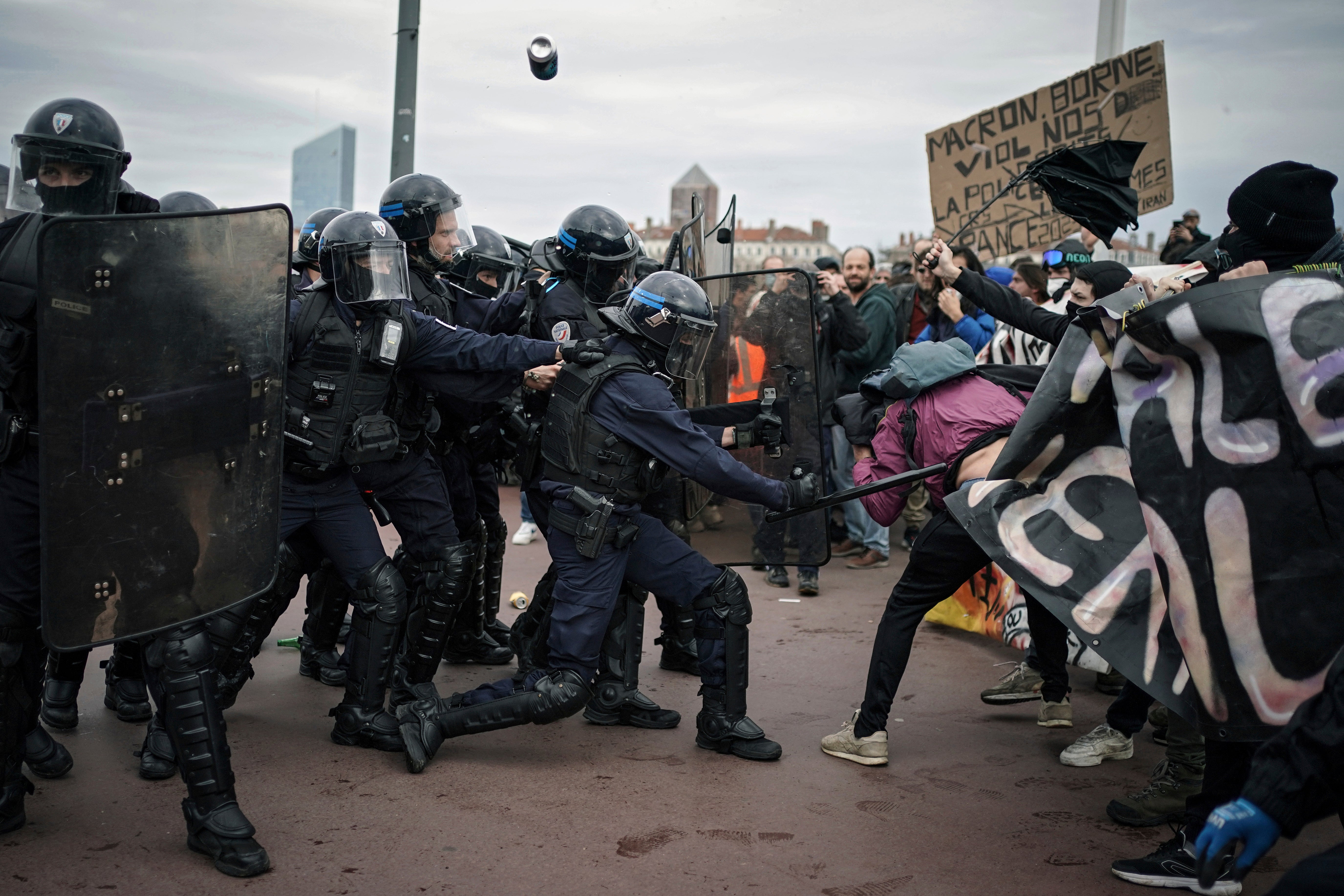 Protesters clash with police officers during a demonstration in Lyon, central France