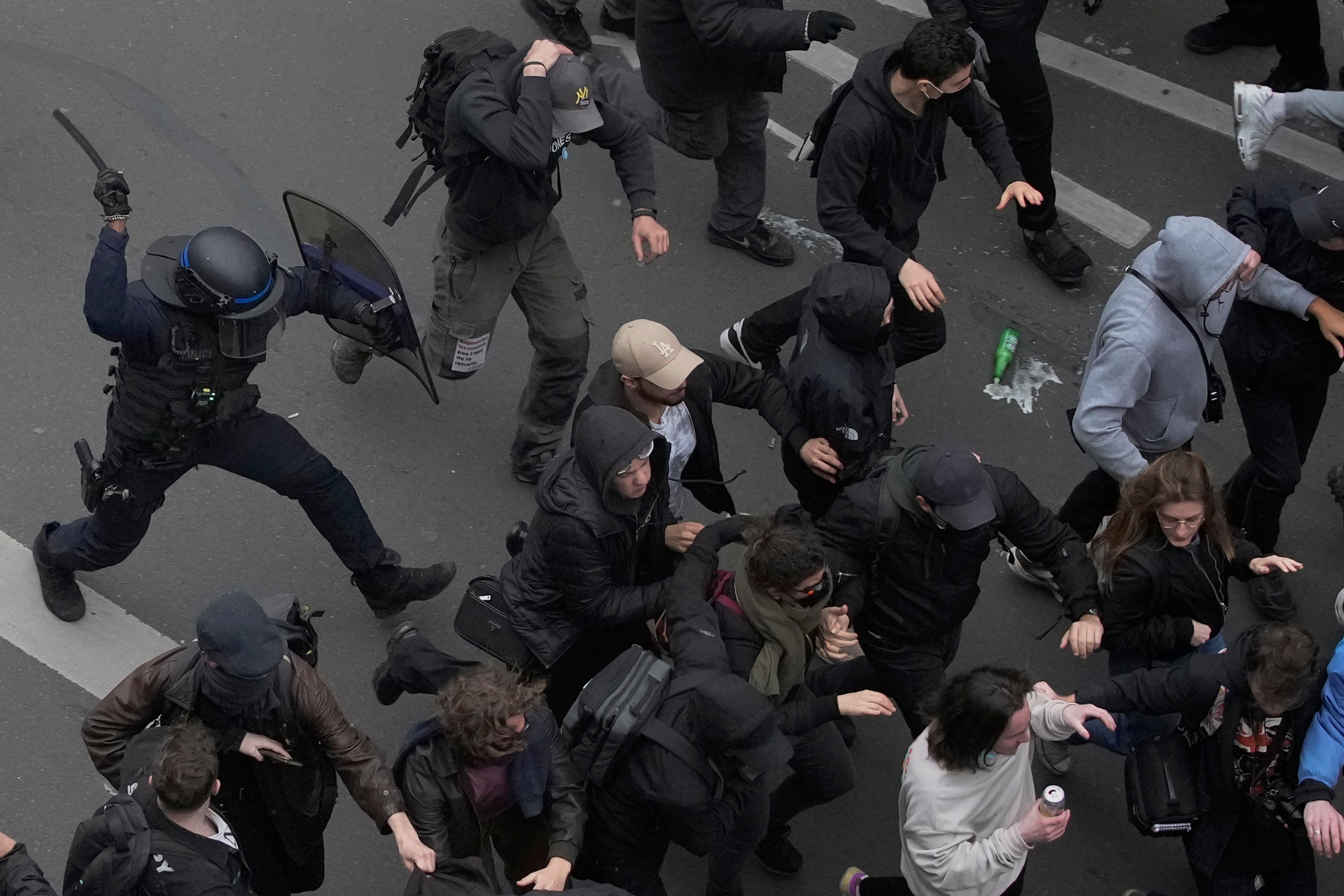 Riot police scuffle with protesters during a rally in Paris on Thursday