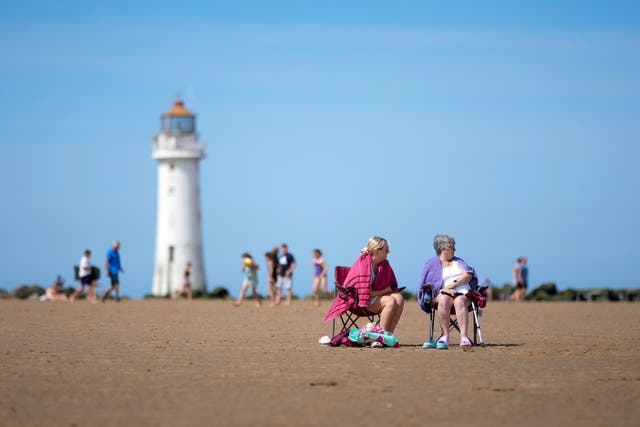 <p>People enjoy the warm weather and sunshine on New Brighton beach and promenad </p>