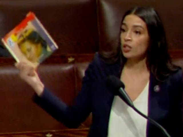 <p>Congresswoman Alexandria Ocasio-Cortez holds up a copy of ‘The Life of Rosa Parks,’ which she said had been banned by a Florida school</p>