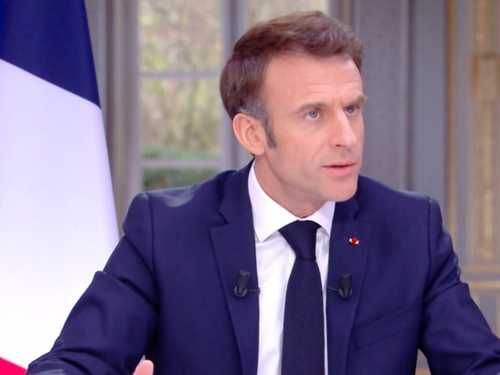 Emmanuel Macron could be seen removing his watch during the televised interview