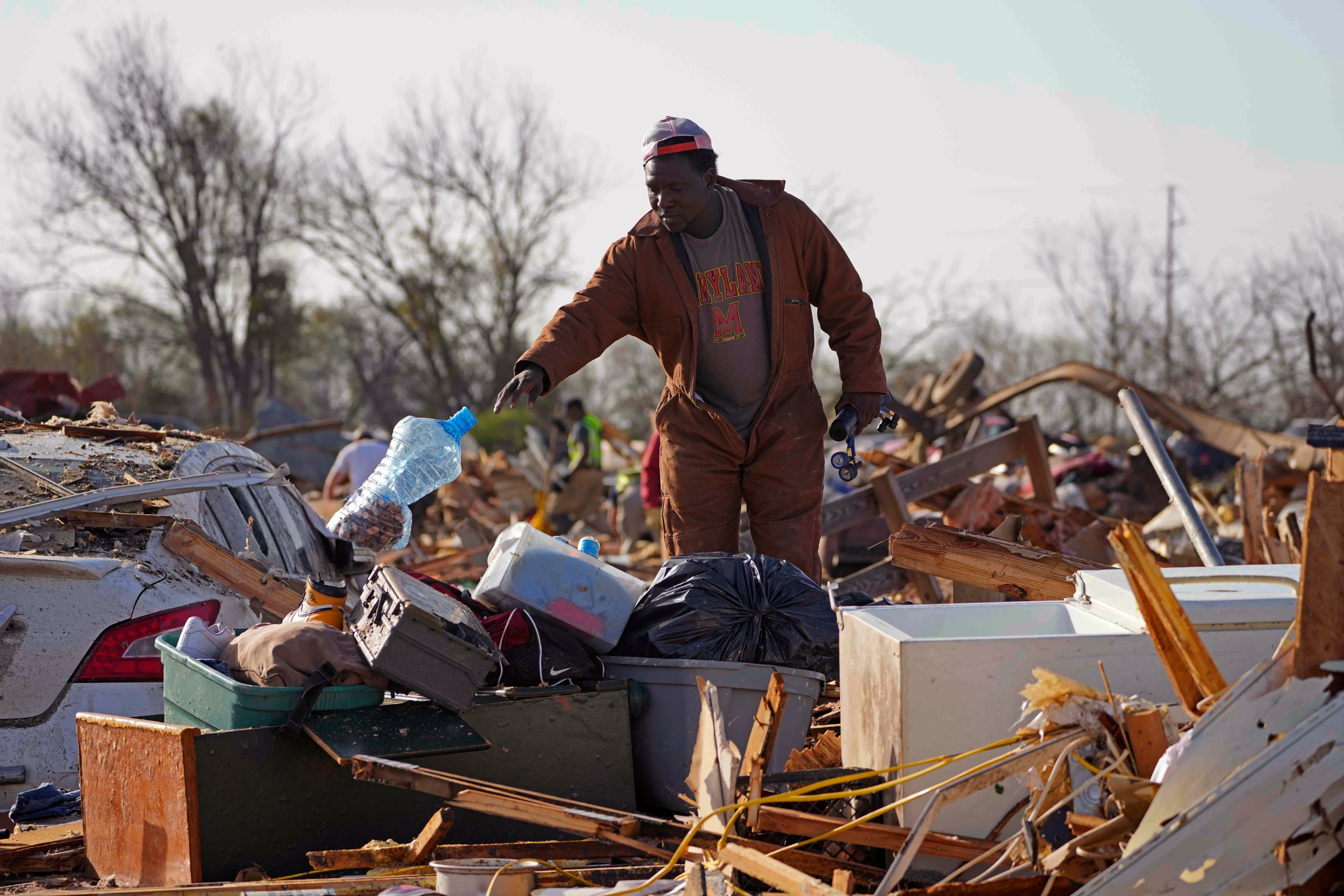 A Mississippi resident surveys the damage after a tornado cut a 170-mile path through the state and neighboring Alabama