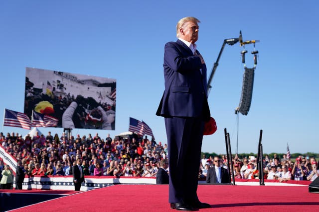 <p>Former President Donald Trump stands while a song, "Justice for All," is played during a campaign rally at Waco Regional Airport, Saturday, March 25, 2023, in Waco, Texas</p>
