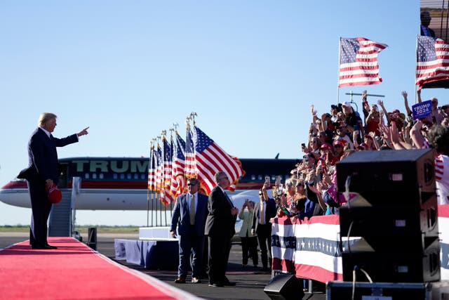 <p>Former President Donald Trump points to supporters as he arrives to speak at a campaign rally at Waco Regional Airport, Saturday, March 25, 2023</p>