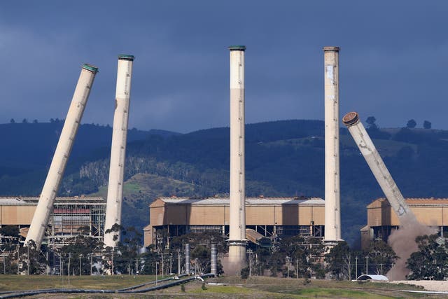 <p>Some of the coal-burning Hazelwood Power Station's eight chimneys begin to topple as they are demolished and the station is decommissioned in Hazelwood, Victoria</p>