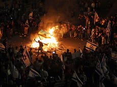 Israeli protesters light bonfires and block highway after Netanyahu sacks minister