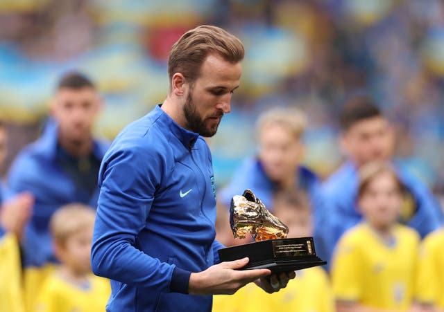 <p>Harry Kane receives a Golden Boot trophy after becoming England’s record scorer</p>