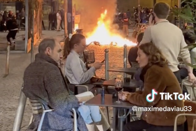 <p>Diners at Place de la Victoire, in the southern wine-growing region of Bordeaux on Thursday, appeared unphased as they sat near the flames</p>