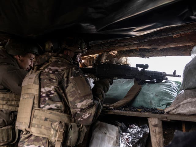 <p>Ukrainian soldiers from the 24th Separate Mechanised Brigade use a US-made M240 machine gun to shoot towards Russian positions</p>