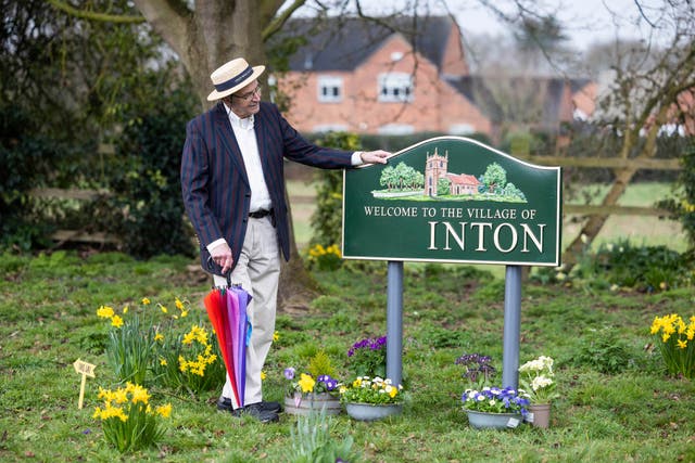 Local Chris Marples looks at a sign where the ‘egg’ is missing in Egginton, Derbyshire (Fabio de Paola/PA)