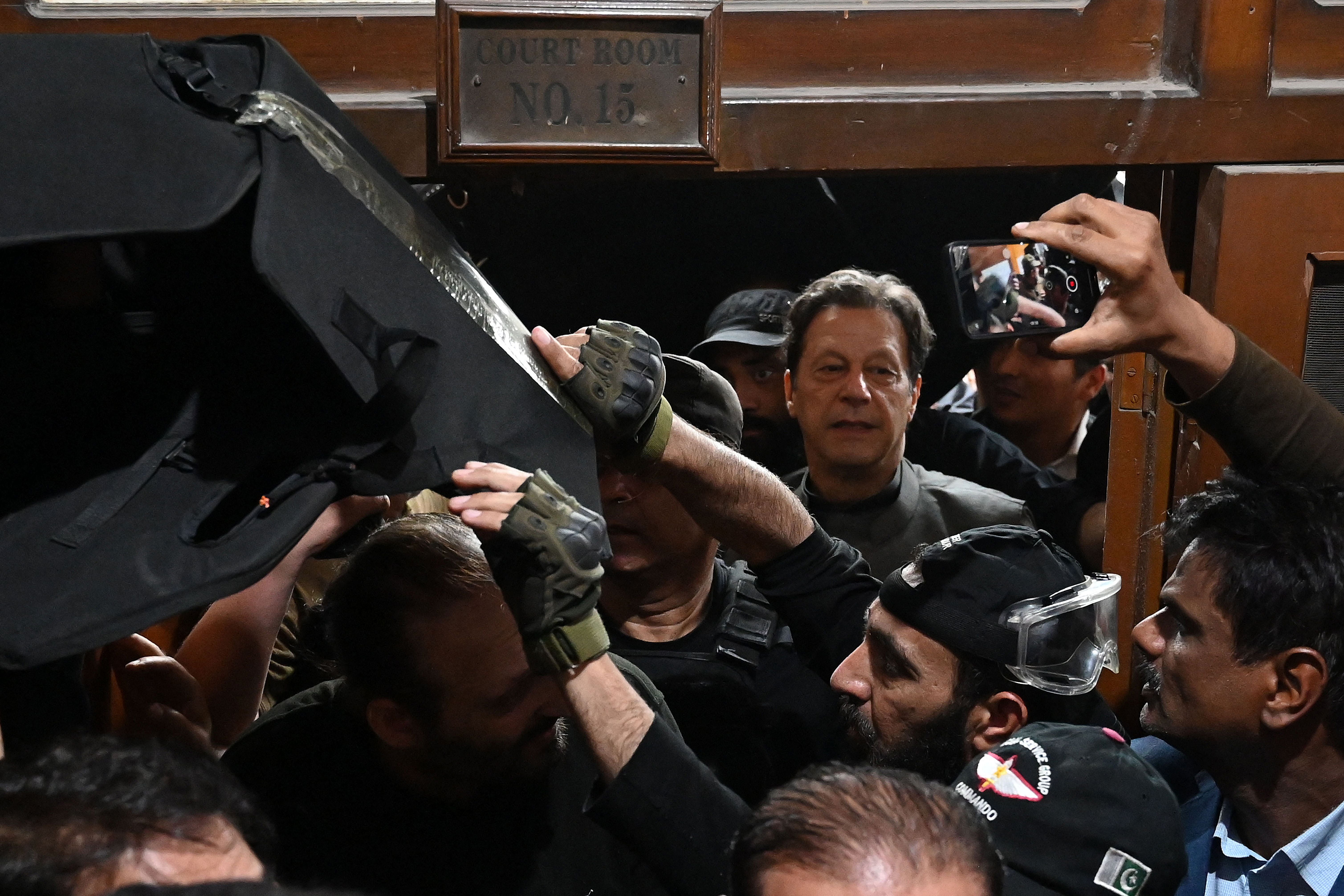 <p>Pakistan’s former prime minister Imran Khan leaves after appearing before a court for a protective bail in relation to two cases, in Lahore on 21 March</p>