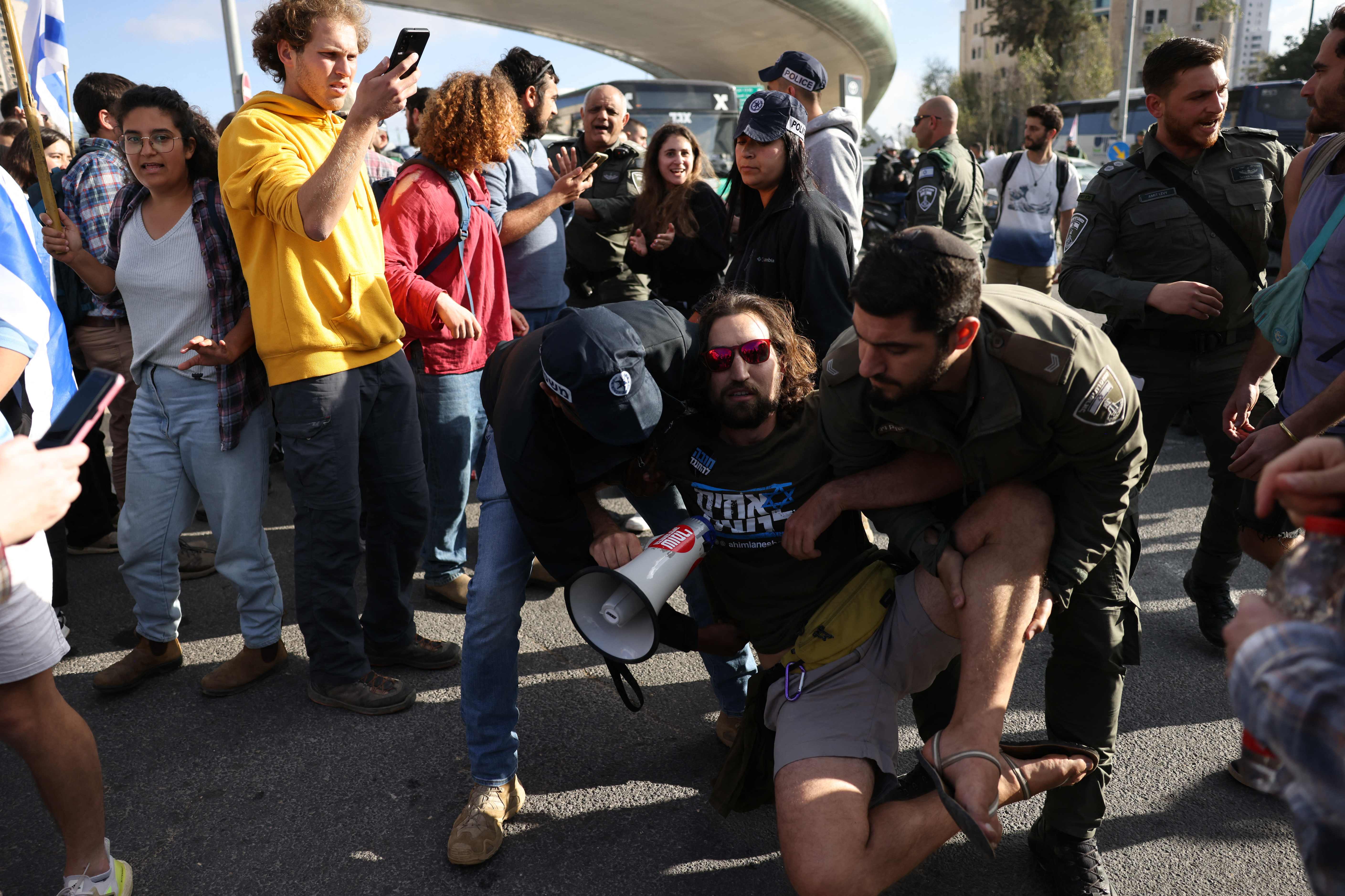 <p>Israeli police detain a protester outside Israel's parliament in Jerusalem</p>