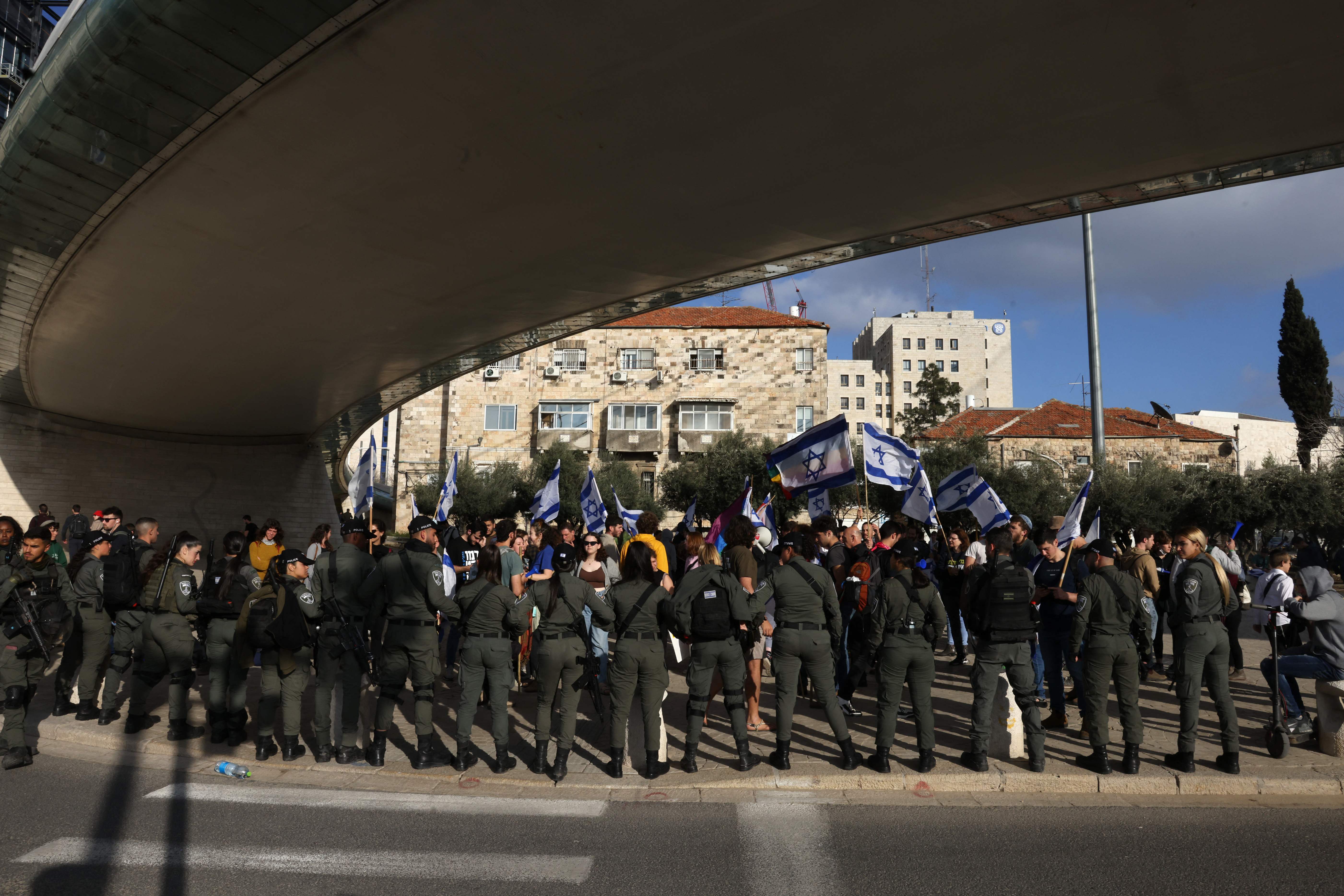 Israeli police stand guard as protesters gather outside Israel’s parliament