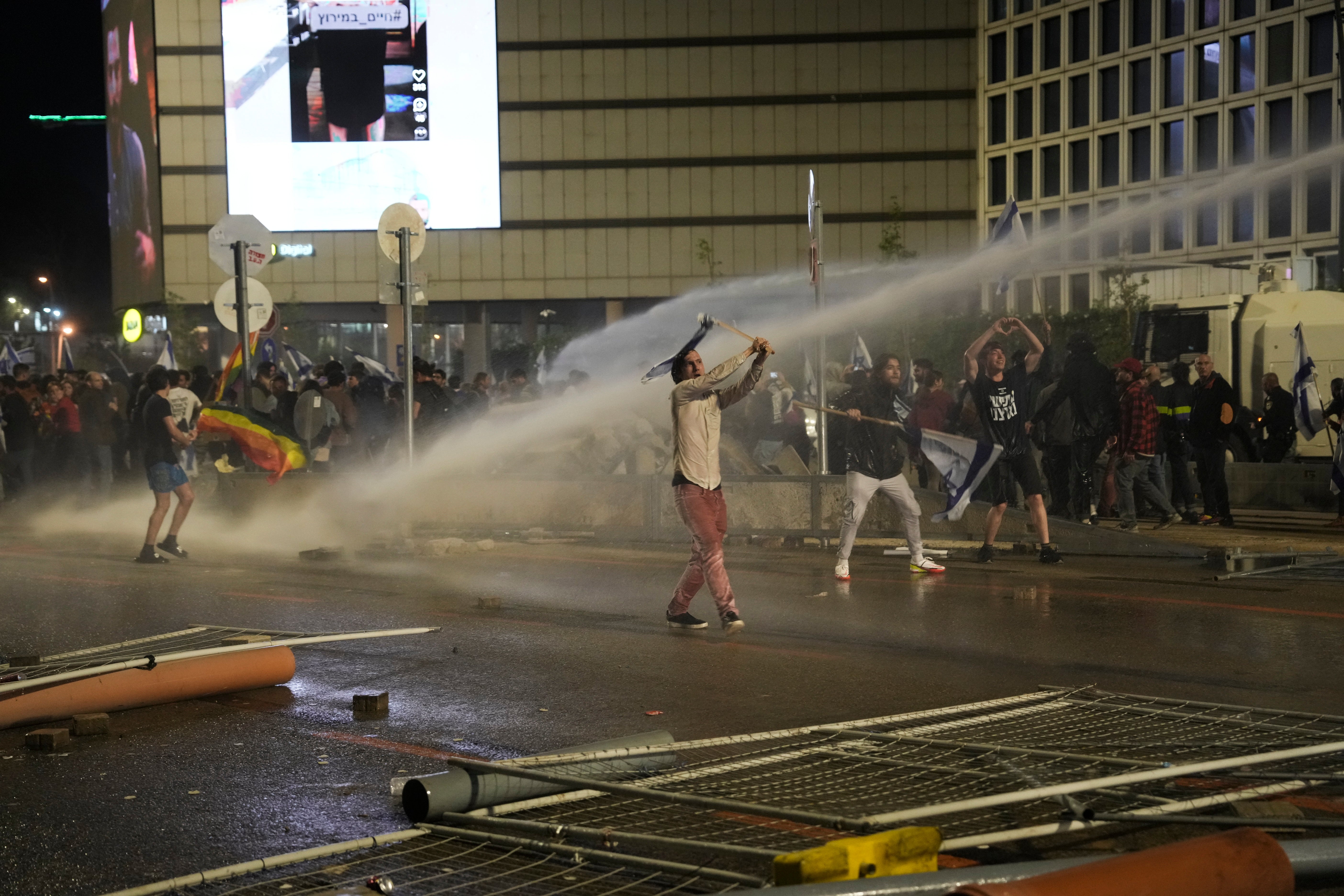 Police use water canon to disperse anti government protesters in Tel Aviv, Israel, Monday, March 27, 2023.