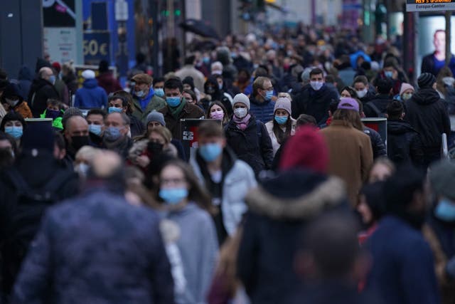 <p>Shoppers crowd Tauntzienstrasse shopping street on Black Friday weekend during the second wave of the coronavirus pandemic on November 28, 2020 in Berlin, Germany</p>