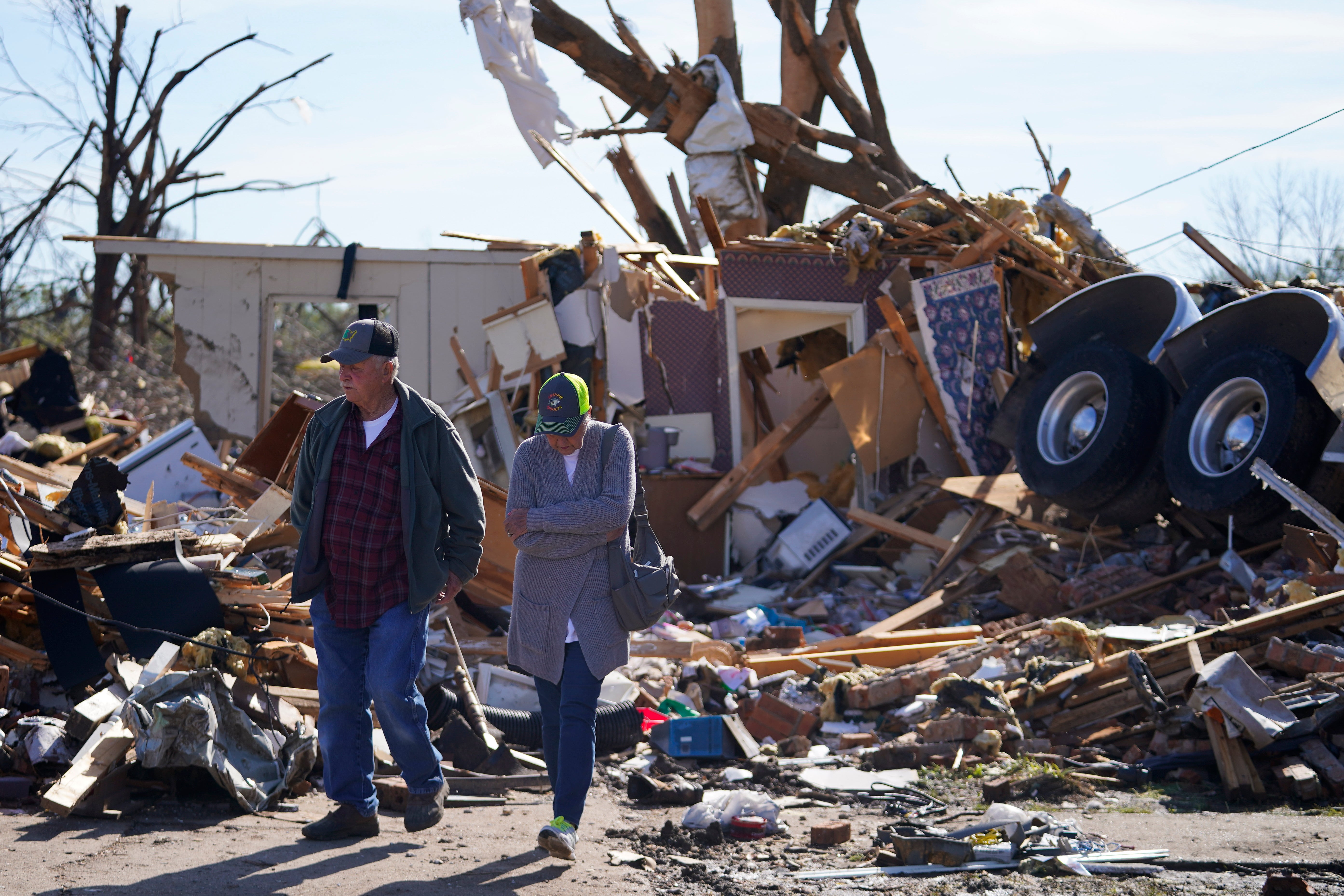 Two residents of Rolling Fork, Mississippi, visit the house of two friends who were killed when a semi truck landed on their home on Friday 24 March 2023