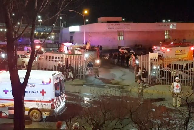 <p>Image taken from a video showing ambulances and rescue teams staffers outside the immigration centre </p>