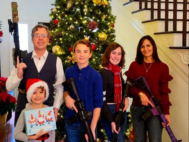 <p>Andy Ogles and his family pose for a 2021 Christmas photo with firearms in an image published on his Facebook page</p>