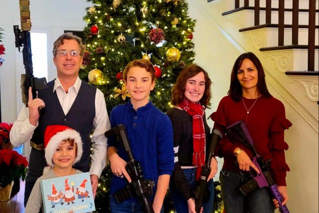 <p>Andy Ogles and his family pose for a 2021 Christmas photo with firearms in an image published on his Facebook page</p>