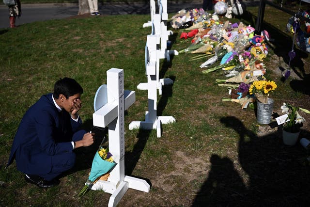 <p>People pay their respects at a makeshift memorial for victims at the Covenant School building at the Covenant Presbyterian Church</p>