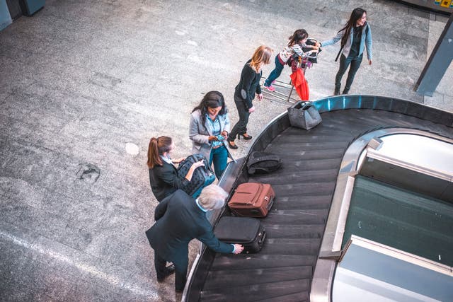 <p>Passengers wait for luggage at the airport</p>