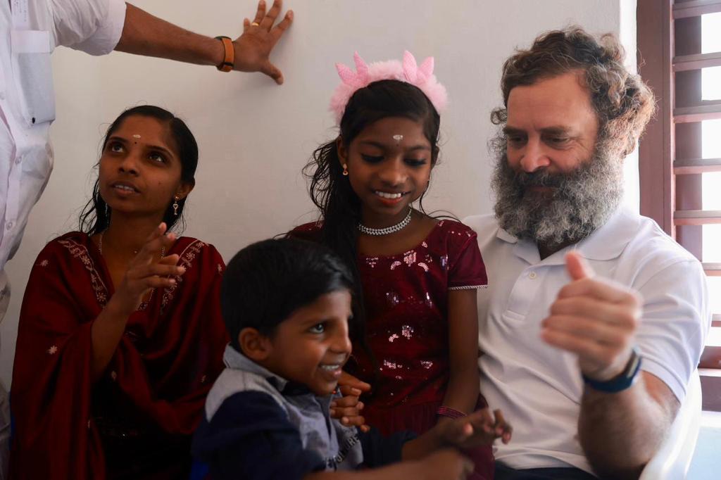 Rahul Gandhi with Jiji, a beneficiary of a housing project called Kaithangu, meaning helping hand, and her children at their new house in Wayanad in March