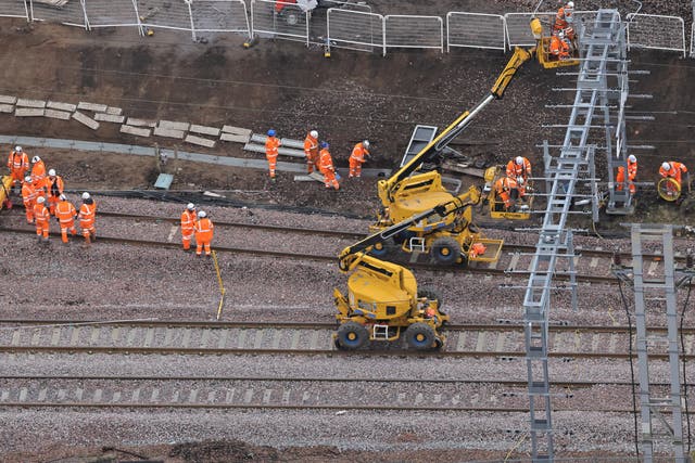 <p>On track: Network Rail engineers at Carstairs in southern Scotland in March 2023</p>