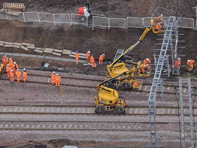 <p>On track: Network Rail engineers at Carstairs in southern Scotland in March 2023</p>