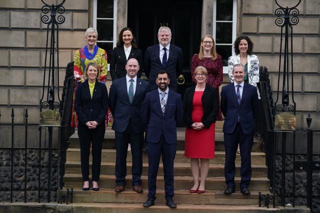 Newly elected First Minister of Scotland Humza Yousaf, centre, with his new Cabinet (Andrew Milligan/PA)