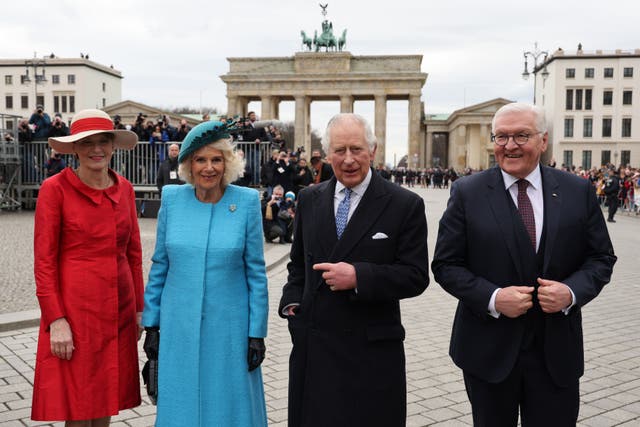 German President Frank-Walter Steinmeier, right, and his wife Elke Buedenbender, left, with the King and the Queen Consort during the ceremonial welcome at Brandenburg Gate, Berlin, at the start of their state visit to Germany (Adrian Dennis/PA)