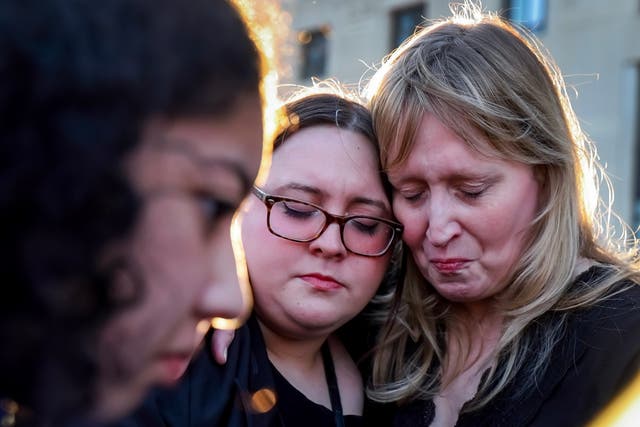 <p>People react during a memorial vigil for the victims of the Covenant Presbyterian Church school shooting in Nashville</p>