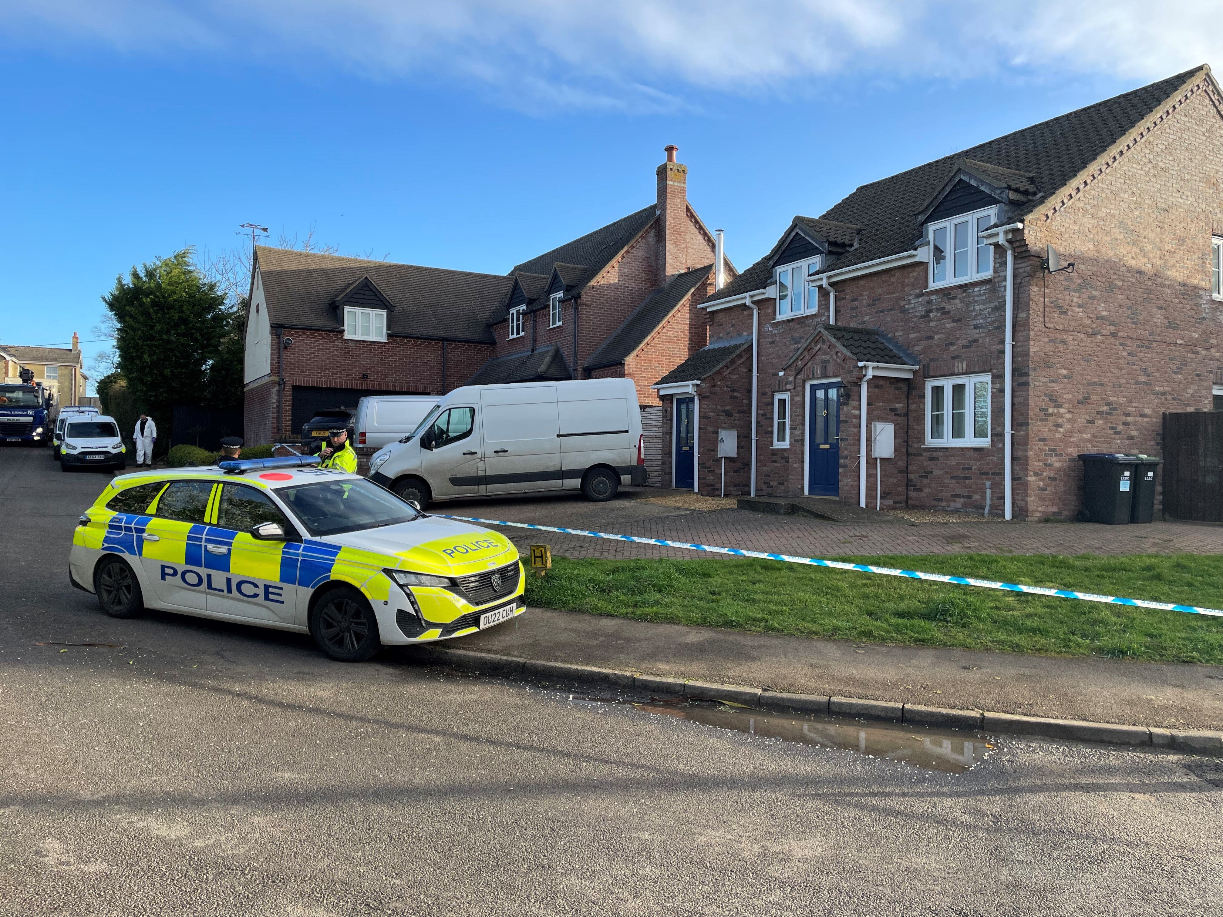 Police at the scene in The Row in Sutton, near Ely, where police found the body of a 57-year-old man