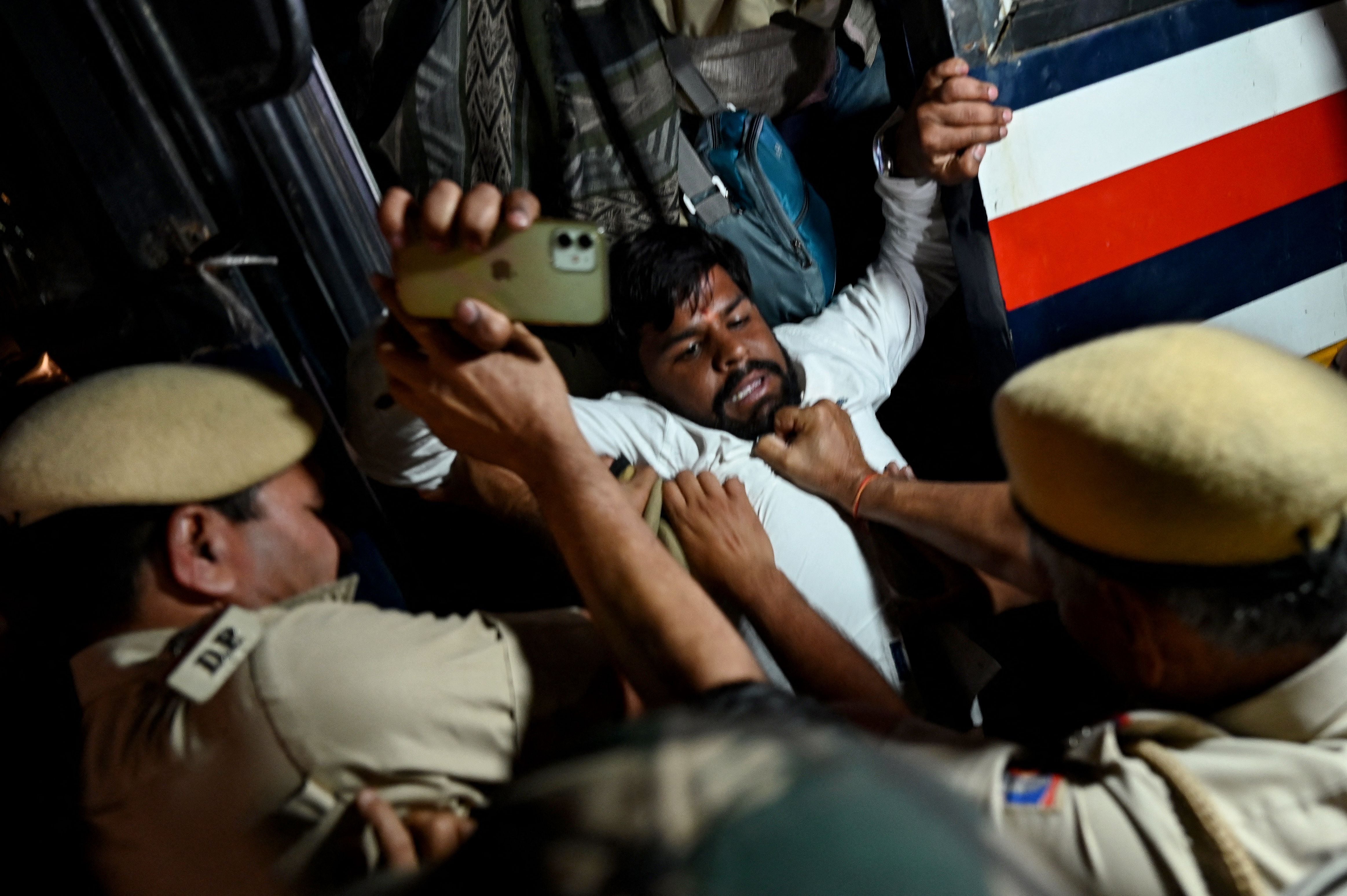 Police personnel detain activists and supporters of India's Congress party