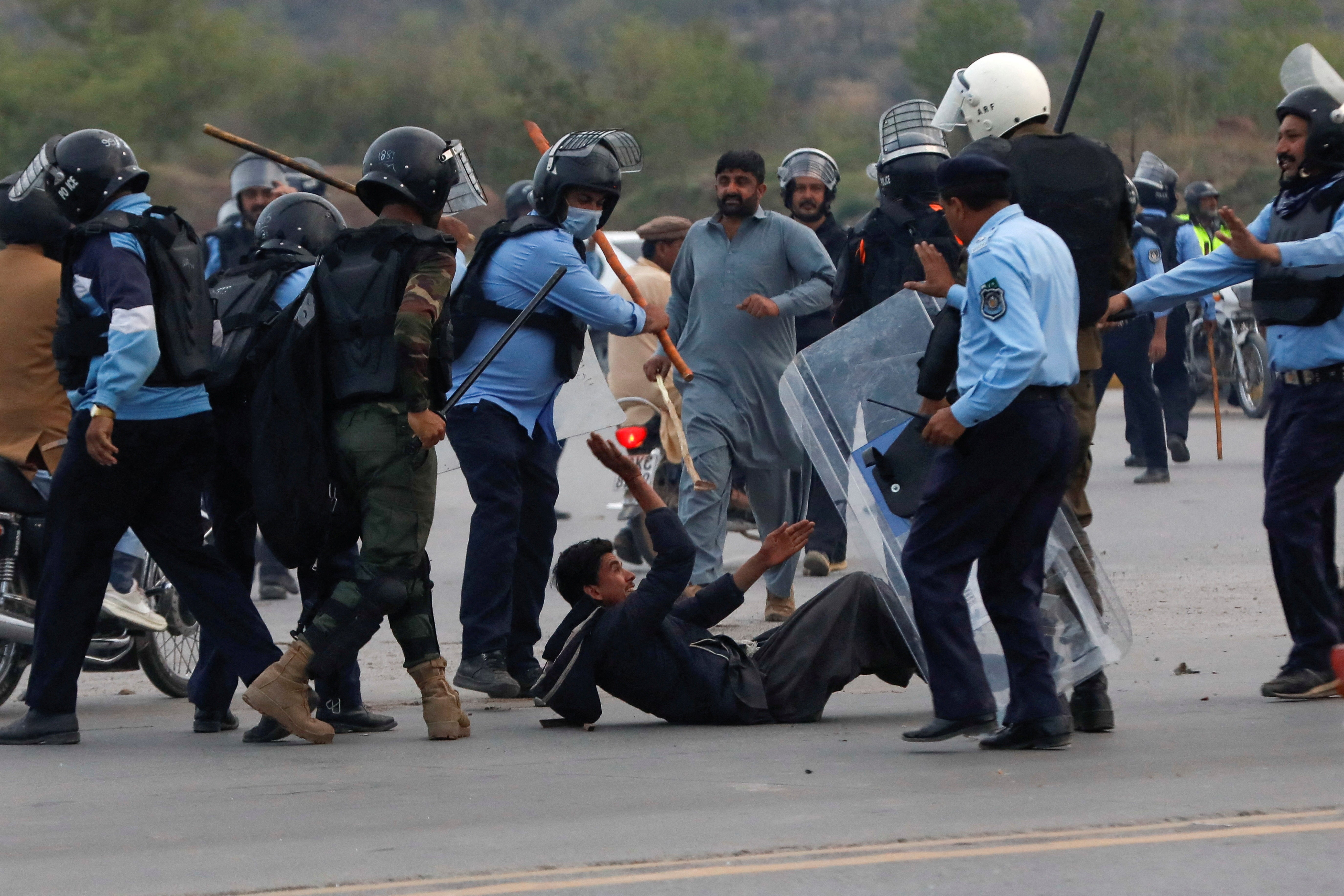 Police clash with supporters of Imran Khan outside the judicial complex in Islamabad where he was due to appear on 18 March