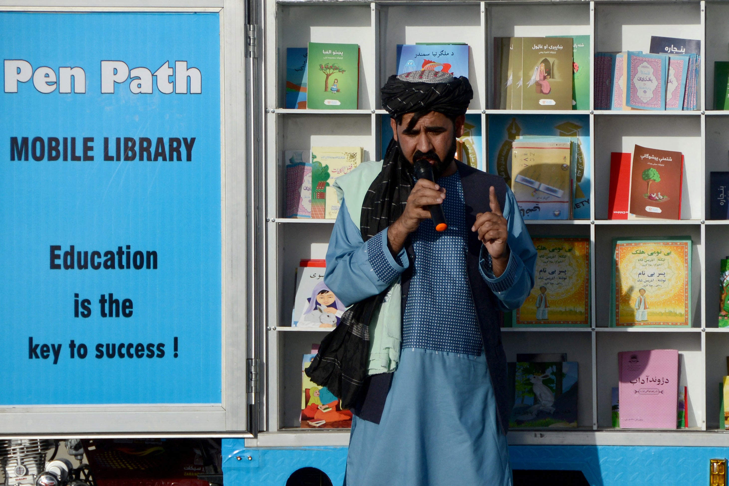 Matiullah Wesa, head of PenPath and advocate for girls’ education in Afghanistan, speaks to children during a class next to his mobile library in Spin Boldak district of Kandahar Province