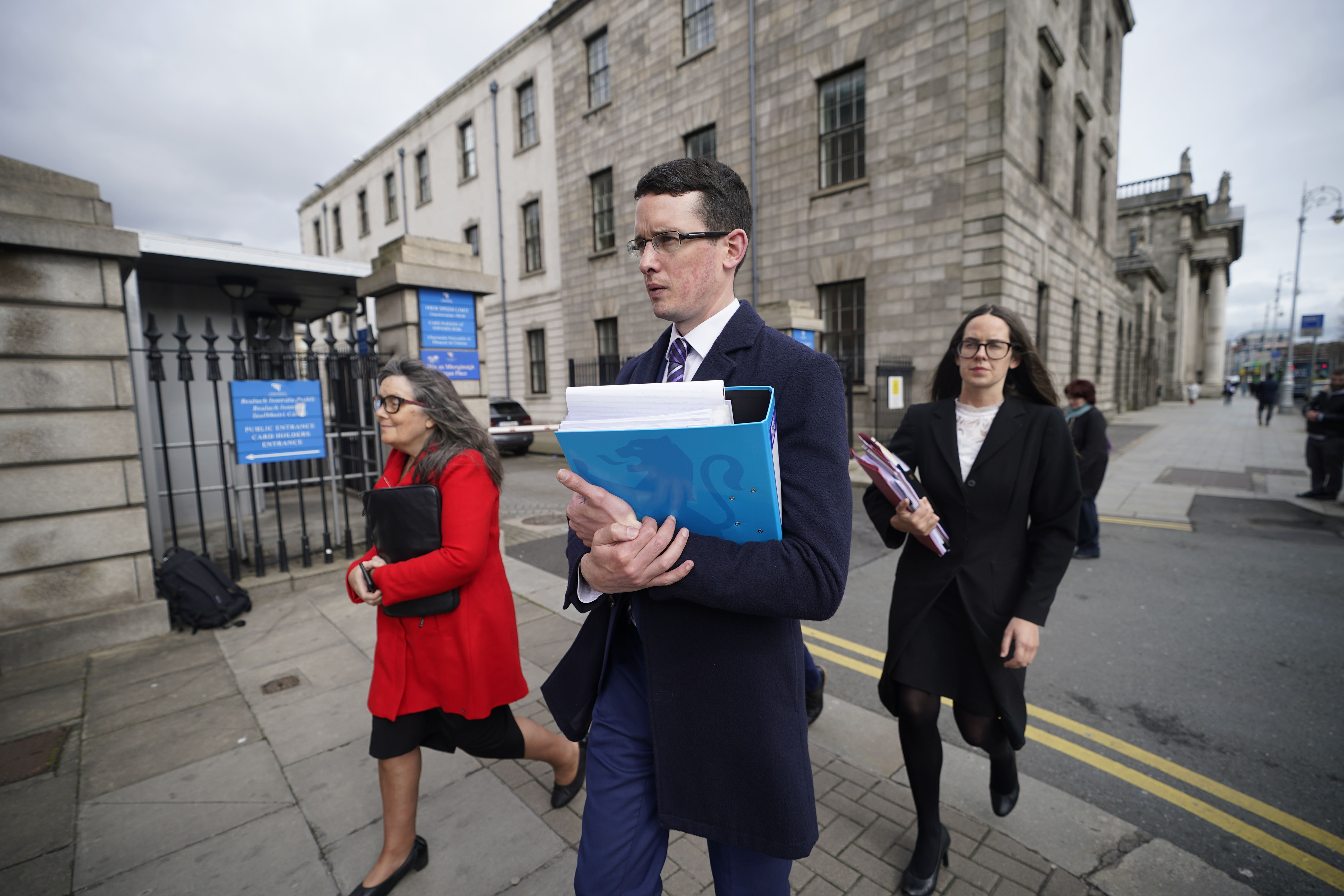 Irish teacher Enoch Burke, with his mother Martina Burke, left, and his sister Ammi Burke outside the High Court in Dublin (Niall Carson/PA)