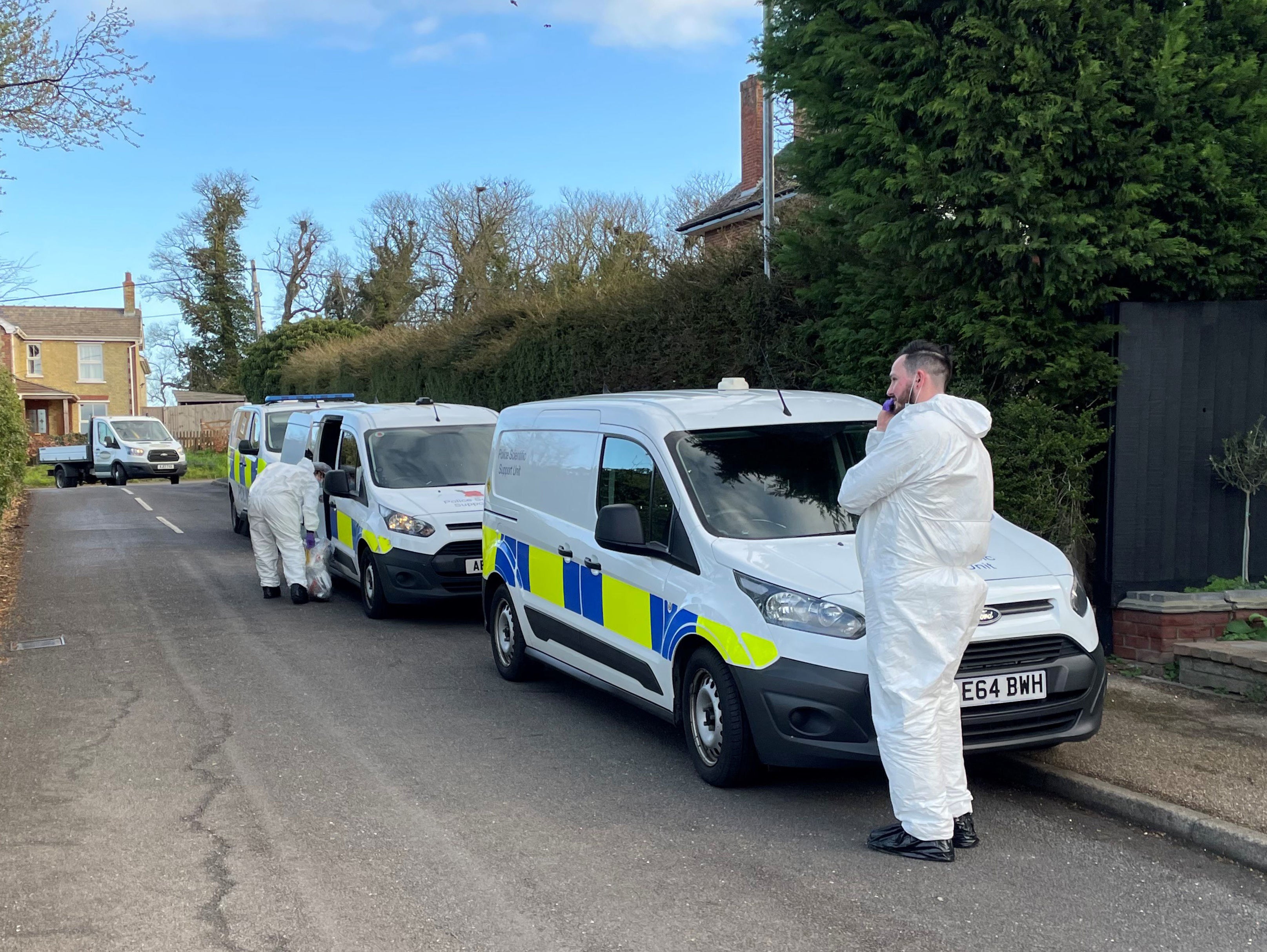 Police forensics officers at the scene in The Row in Sutton, near Ely